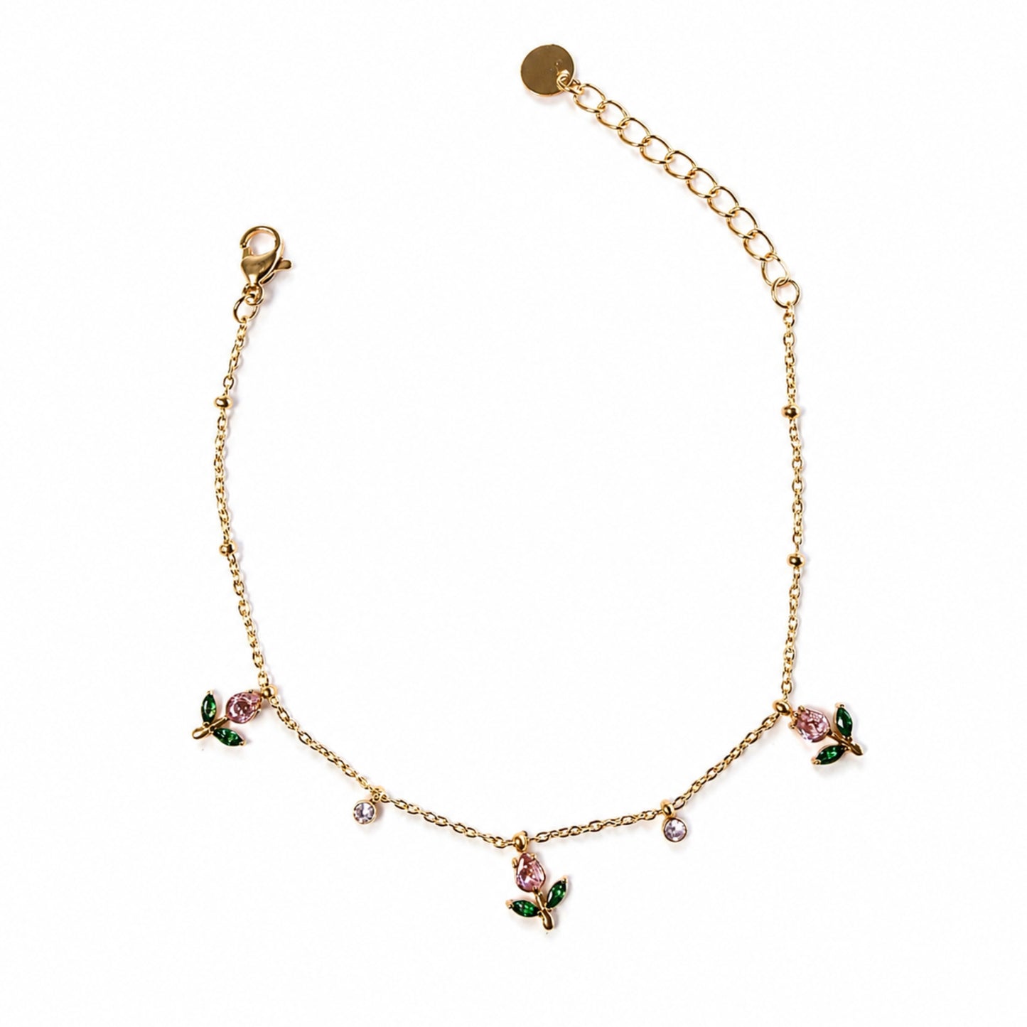Bracciale Rugiada dorato in acciaio inox con charm floreali rosa, foglie verdi e piccoli cristalli luminosi